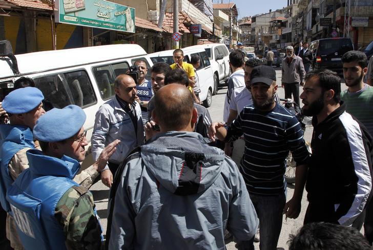 United Nations observers talk with local residents during a field visit to the Madaya area, near Damascus May 6, 2012. 