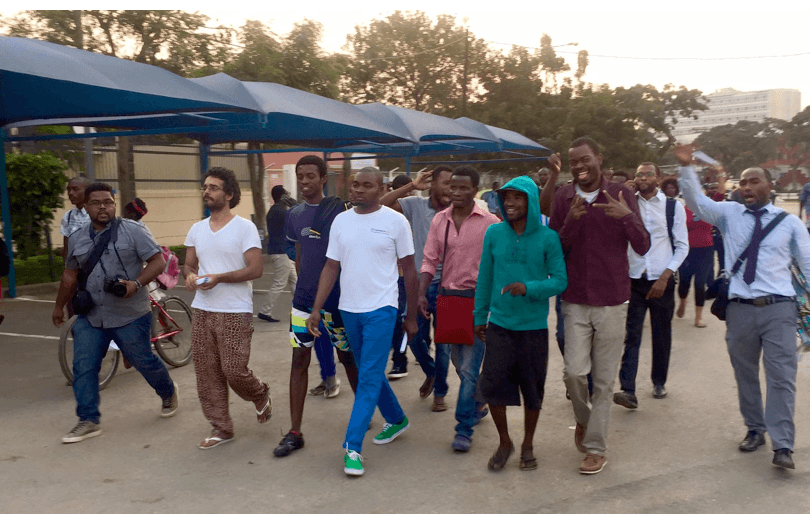 Book-club activists walk through the streets of Luanda after their provisional release.