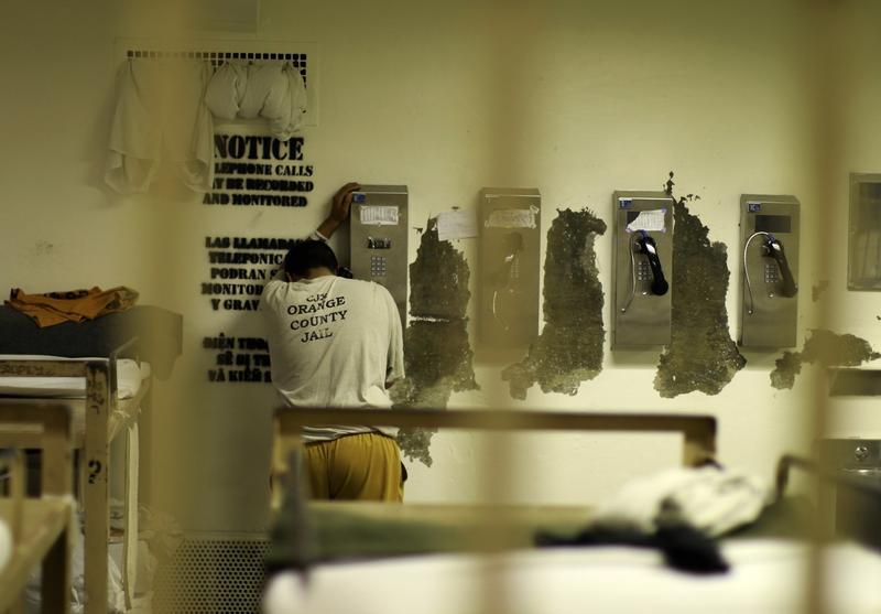 An inmate makes a phone call from his cell at the Orange County jail in Santa Ana, California, May 24, 2011.