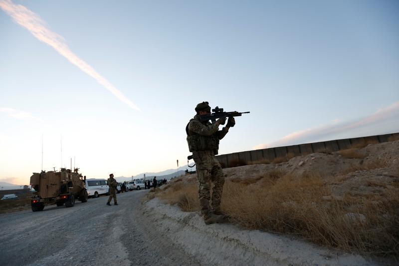 A British soldier looks through the scope of a machine gun to observe an area in Kabul, Afghanistan November 26, 2016.
