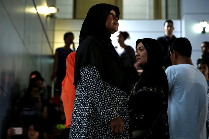 Relatives of victims of human trafficking wait for the sentence after an army general, two provincial politicians and police officers were among the 46 people held guilty in a court in Bangkok, Thailand, July 19, 2017.