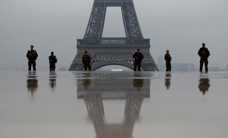 French soldiers patrol near the Eiffel Tower as part of the "Sentinelle" counterterrorism security plan in Paris, France, May 3, 2017. © 2017 Reuters