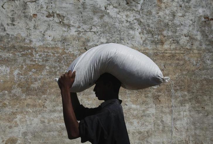 201712asia_pakistan_ngos2 A flood victim carries a sack of flour on his head from a distribution point while heading to his village of Murad Chandio, some 35 km (22 miles) from Dadu in Pakistan's Sindh province January 26, 2011. 