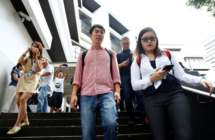 Activist Jolovan Wham (center) leaves the State Court after a hearing in Singapore, November 29, 2017. © 2017 REUTERS/Edgar Su