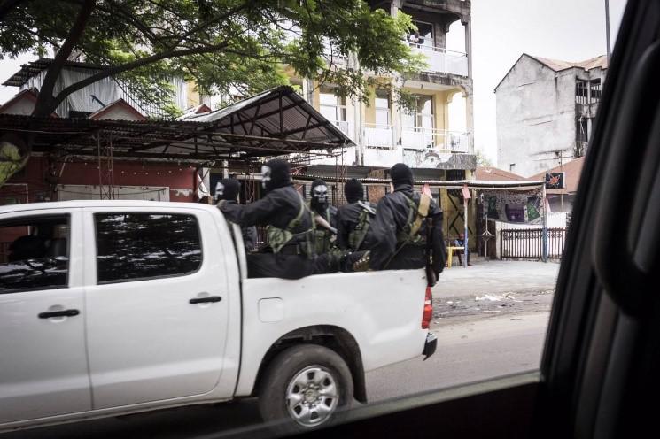 Armed members of the security forces wear black and white skeleton masks, apparently to intimidate protesters, in Kinshasa, January 21, 2018.