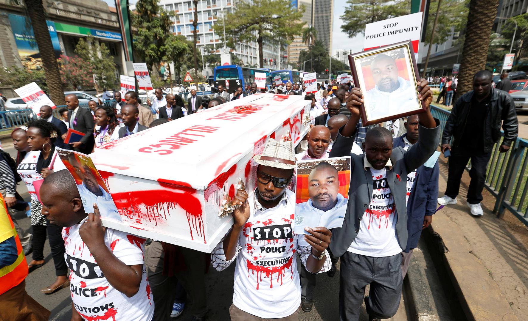 Protesters carry photos of taxi driver Joseph Muiruri, who was killed extrajudicially alongside human rights lawyer Willie Kimani and his client, in Nairobi, Kenya, on July 4, 2016.