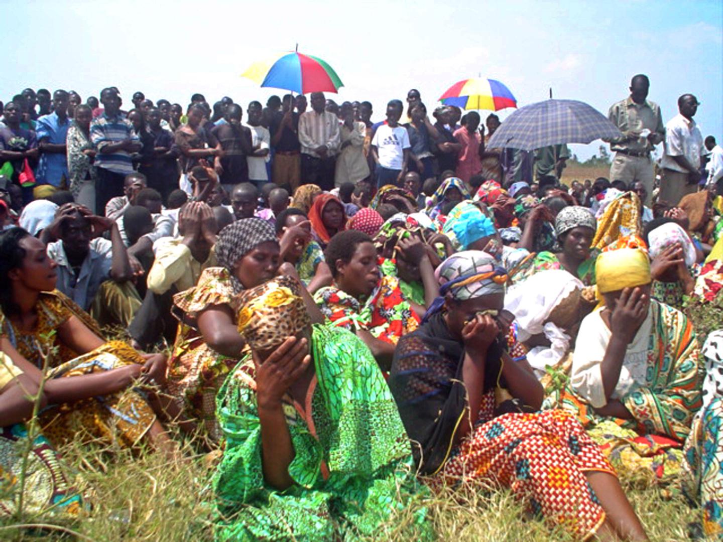 Mourners gather during a mass funeral service for the more than 150 Congolese who were massacred the previous weekend, at Gatumba, a UN-run refugee camp in Burundi, August 16, 2004.