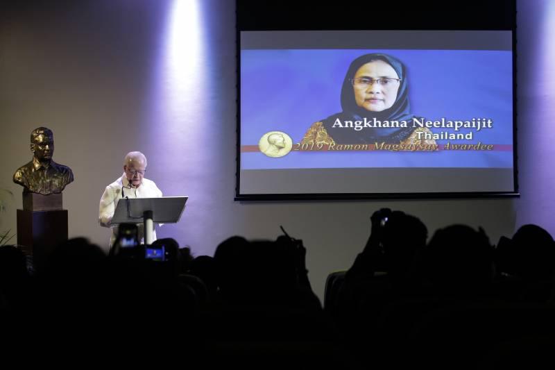 Jose L. Cuisia Jr., chairperson of Ramon Magsaysay Award Foundation, presents the 2019 Ramon Magsaysay awardee Angkhana Neelapaijit from Thailand during an event in Manila, Philippines, Friday Aug. 2, 2019. 