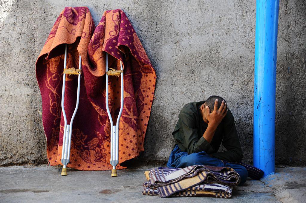 A man sits in the yard at a mental health facility in the city of Herat, April 2014. © 2014 Aref Karimi/AFP/Getty Images