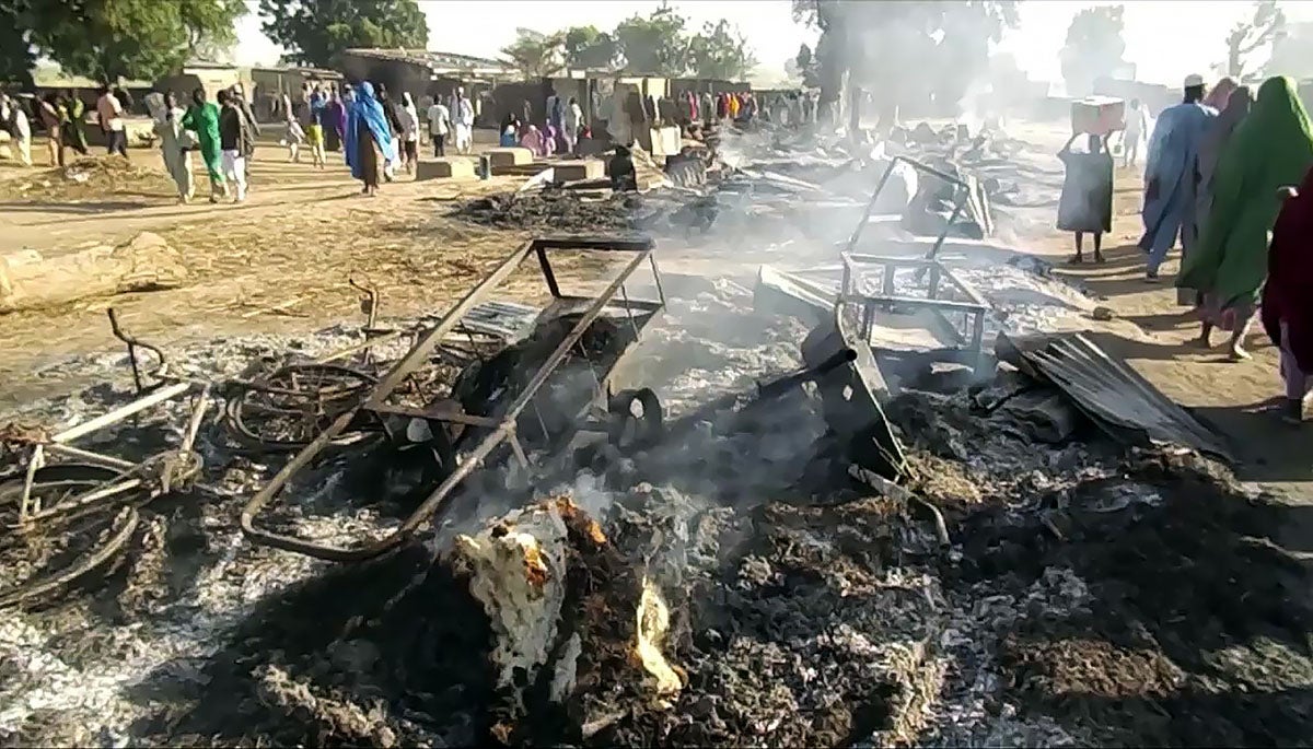 Smoldering ashes and charred items are seen on the ground in Badu near Maiduguri, Nigeria, on July 28, 2019, after a suspected attack by Boko Haram fighters on a funeral.