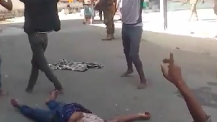 Detainees watch in horror outside the migrant detention facility in Sanaa, Yemen, where scores of Ethiopian migrants burned to death in a fire on March 7, 2021