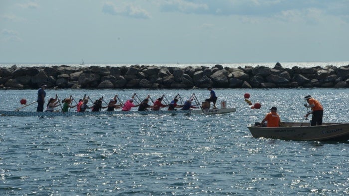 Kaola Baird racing with teammates at the Dragon Boat Race Festival