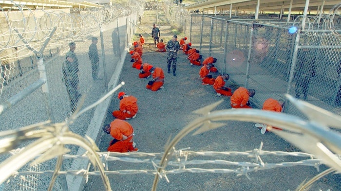 The first foreign Muslim men imprisoned by the US military at the detention center at Guantánamo Bay, Cuba, in the so-called “global war on terror.” Since January 2002, the US has held nearly 800 men and boys at Guantánamo. Of the 39 who currently remain, 27 have never been charged. © 2002 Shane McCoy/Greg Mathieson/Mai/Getty Images