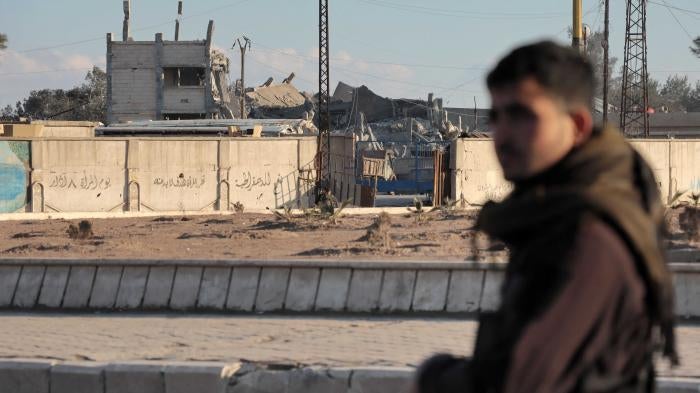 Fighters with the Kurdish-led Syrian Democratic Forces deploy around al-Sina’a prison in the Ghweran district of al-Hasakah, northeast Syria, on January 25, 2022, midway through the 10-day battle to recapture it from the Islamic State (ISIS). © 2022 AFP Photo via Getty Images