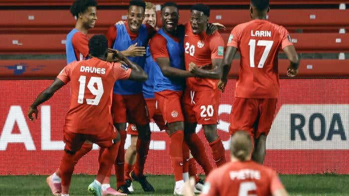 Soccer team celebrates after scoring a goal