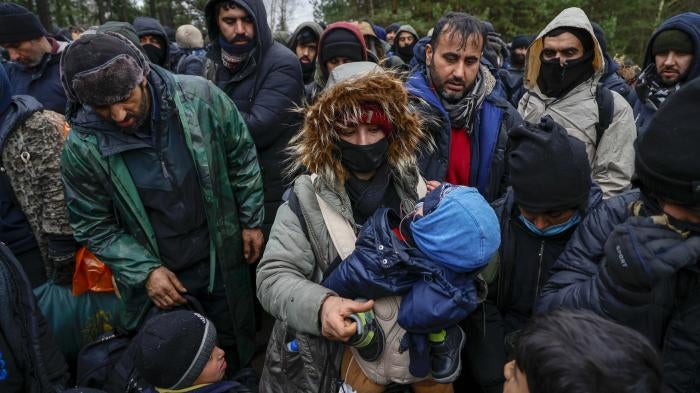 Migrants wait in freezing temperatures near the Bruzgi checkpoint on the Polish-Belarusian border November 18, 2021 in Grodno, Belarus. 