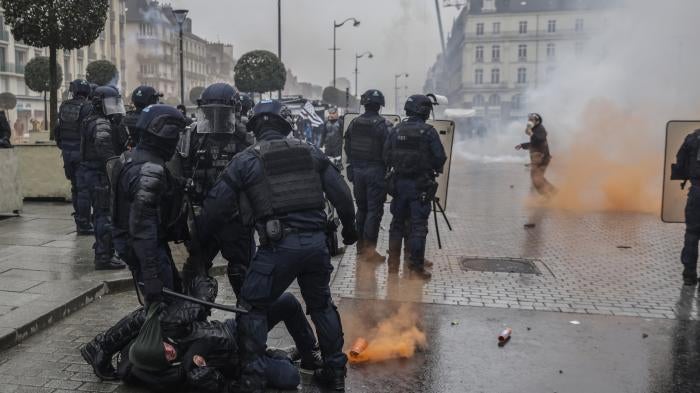 Riot police scuffle with protesters during a protest in Rennes, France.