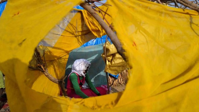 A Sudanese refugee who fled the violence in Sudan's Darfur region, at her makeshift shelter in Koufroun, Chad, May 15, 2023.