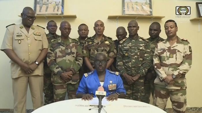 Col. Maj. Amadou Abdramane, front center, with a delegation of military officers, appear on Niger State TV to announce their coup on July 26, 2023, in Niamey, Niger. 