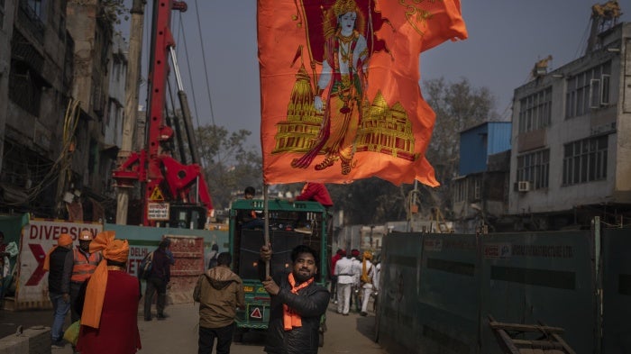 A man waves a flag with the Hindu god Ram to celebrate the opening of the Ram Temple in Ayodhya city, India, January 16, 2024.