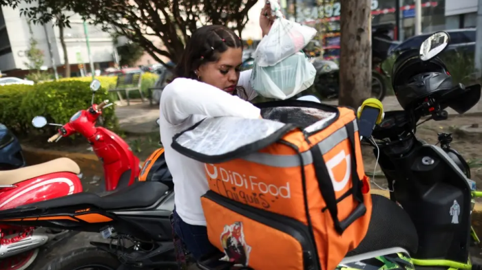 A delivery driver for Didi Food, getting ready to deliver orders, in Mexico City, Mexico, on October 16, 2024, could be one of many workers to benefit from labor reform for workers for digital labor platforms.