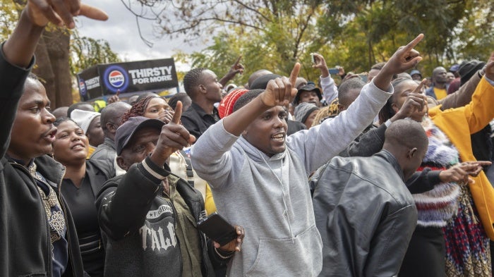 Opposition supporters protest outside a court in Harare, Zimbabwe, June 27, 2024.