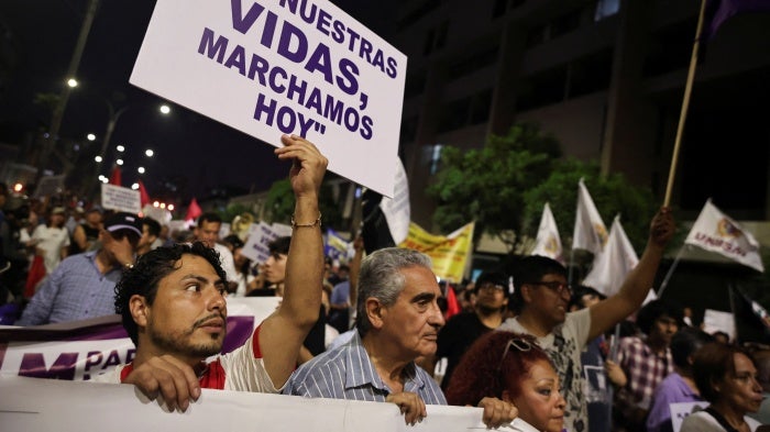 A demonstrator holds a sign which reads, "For our lives, we march today", as people attend a protest against crime and insecurity