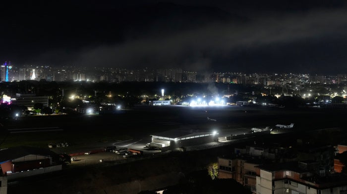 Smoke rises over an airport in Caracas, Venezuela