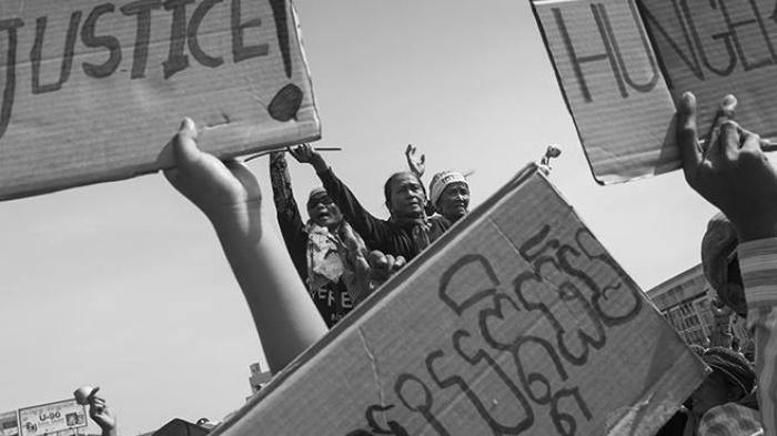 Members of the Boeung Kak Lake community in Cambodia demonstrate at a police blockade in December 2012 on the second day of community activist Yorm Bopha’s trial.