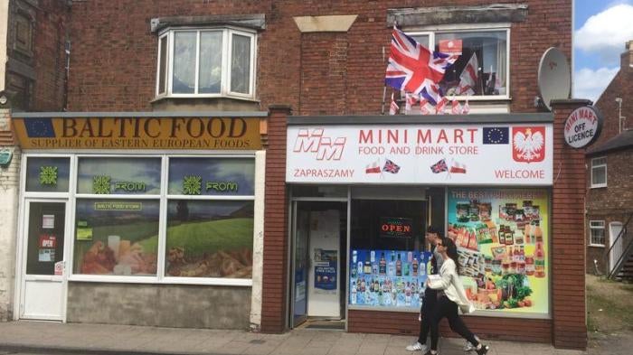 A man and a woman walk past a Polish shop in Boston, Britain June 27, 2016.