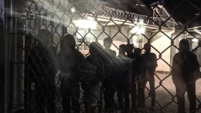Unaccompanied children line up for an evening meal at a detention facility run by the Greek police.