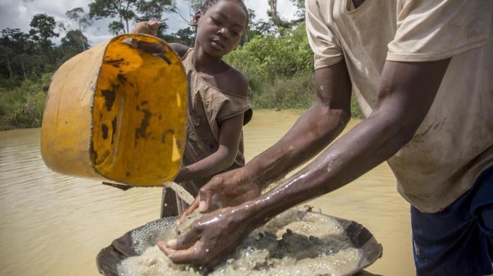 A girl works in an artisanal diamond mine in Sosso Nakombo, Central African Republic, near the border with Cameroon, in August 2015.