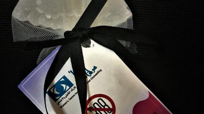 Photo showing a white dress symbolizing a bride produced by the Women’s Centre for Legal Aid and Counselling as part of their campaign to repeal article 308 which had allowed rapists to escape prosecution if they married their victims. The message in Arab