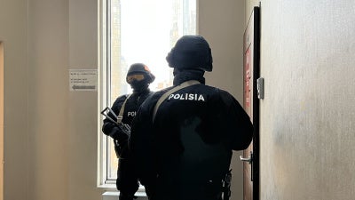Special police force officers stand outside the Orda.kz editorial office in Almaty, Kazakhstan, during a December 1, 2025 search of the premises after authorities opened a criminal case against Gulnara Bazhkenova, the publication's editor-in-chief, for allegedly “disseminating knowingly false information."