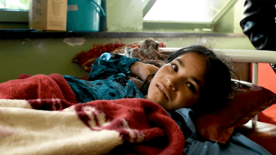 a photo of a child on a hospital bed in Afghanistan.