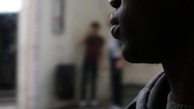 A photo showing one of the migrant teens sleeping in the street in France.