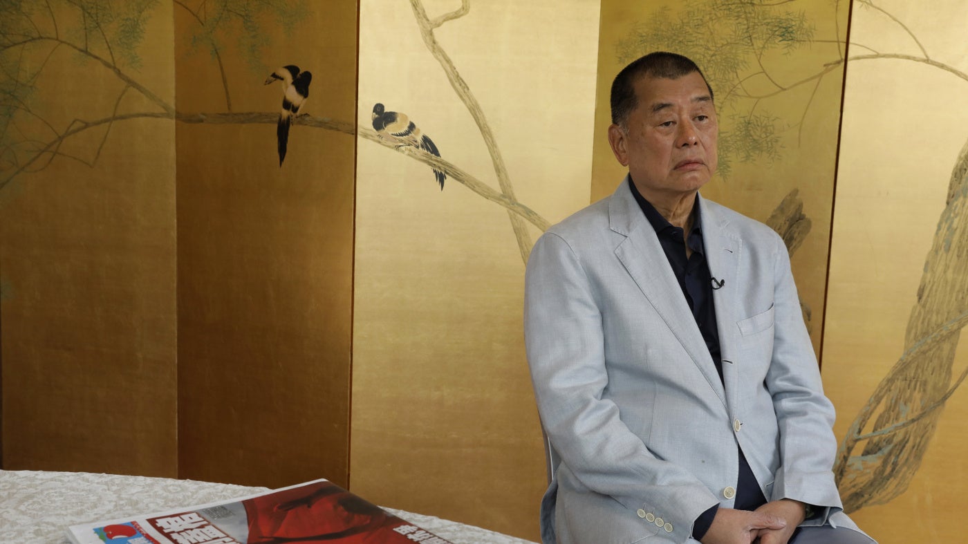 Jimmy Lai with a copy of Apple Daily's July 1, 2020, edition in Hong Kong. 