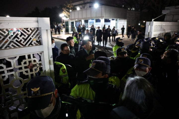 Police officers close the gate of the National Assembly after South Korean President Yoon Suk-yeol declared martial law, in Seoul, December 4, 2024.