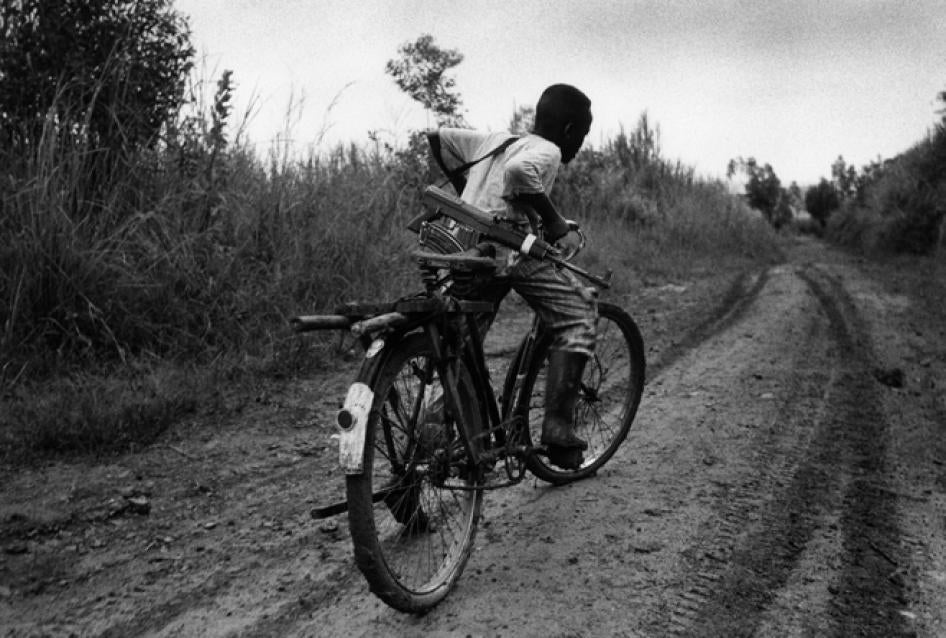 A child soldier rides back to his base in Ituri Province. Children are routinely recruited as soldiers in Congo by all sides.