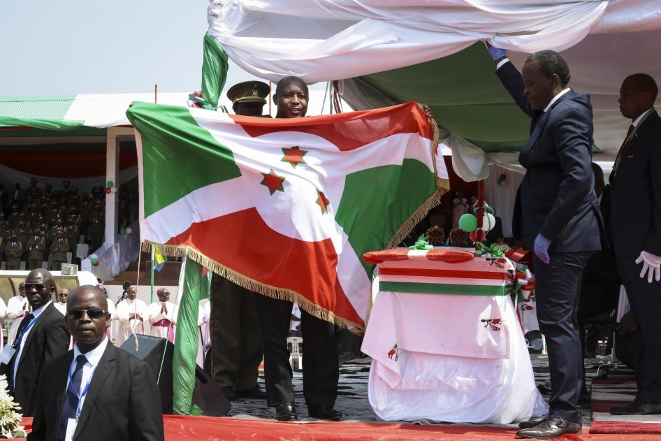 Burundi’s President Evariste Ndayishimiye holds the national flag after his inauguration in Gitega, Burundi, on June 18, 2020. 