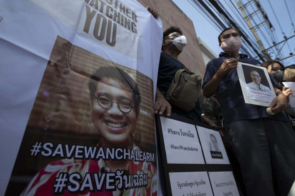 Demonstrators hold photos of Thai activist Wanchalearm Satsaksit and demand information on his whereabouts since his enforced disappearance, at a rally outside the Cambodian embassy in Bangkok, Thailand,  June 8, 2020. 