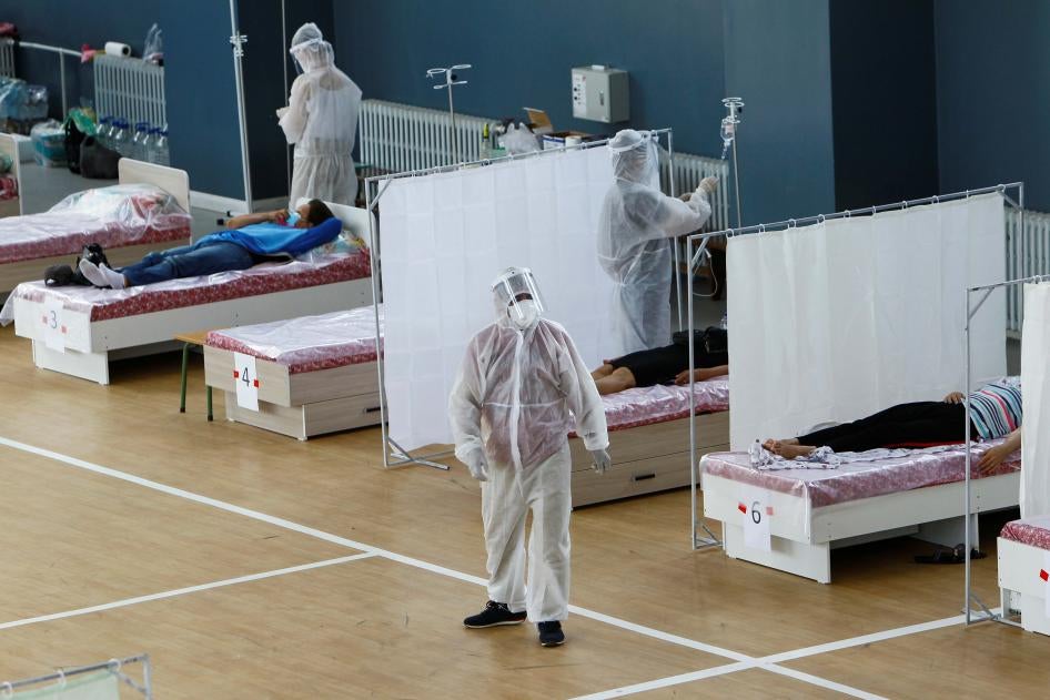 Medical specialists wearing personal protective equipment (PPE) treat patients at a day hospital, which is located in a school gym and provides services free of charge, in Bishkek, Kyrgyzstan July 16, 2020.