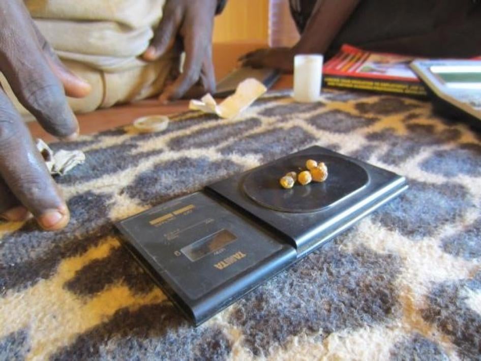 Gold nuggets being weighed by a gold trader