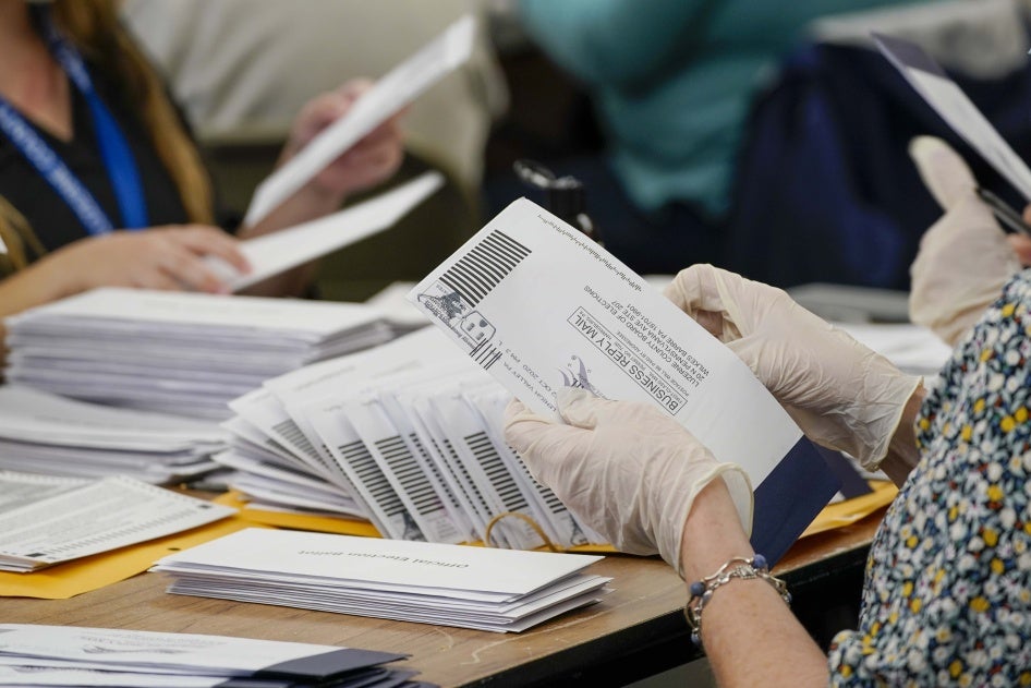 Municipal workers extract Luzerne County ballots from their envelopes, Wednesday, November 4, 2020, in Wilkes-Barre, Pennsylvania. 