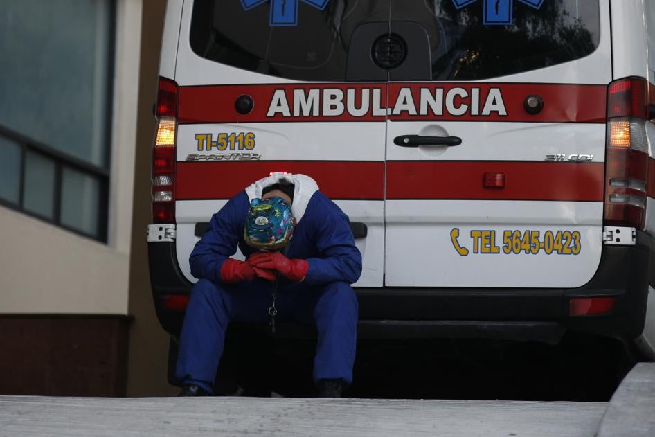 A paramedic rests behind his ambulance, as ambulance staff wait hours for the Covid-19 patients they are transporting to be admitted, at Siglo XXI National Medical Center in Mexico City, Thursday, Jan. 7, 2021. 