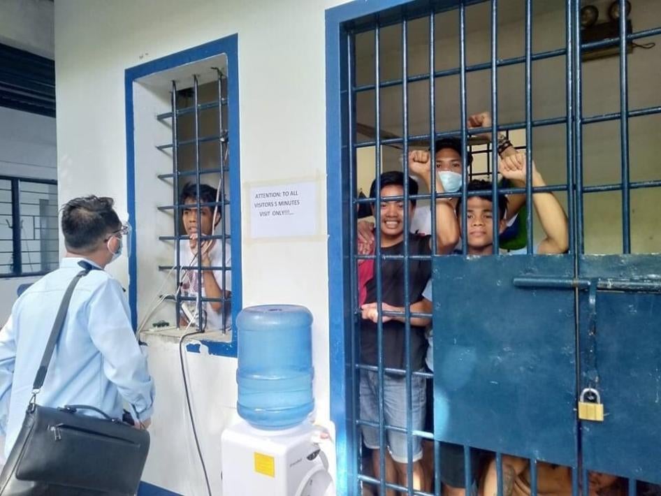 Arrested teachers and adult Indigenous students confer with their lawyer while detained in a Cebu City jail. 