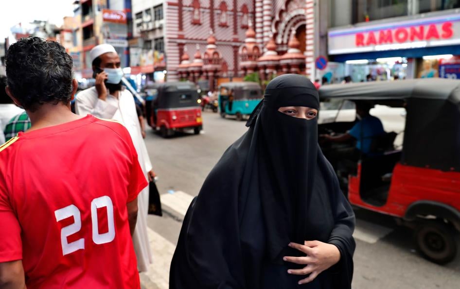 A Sri Lankan Muslim woman wearing a burka walks in a street in Colombo, Sri Lanka