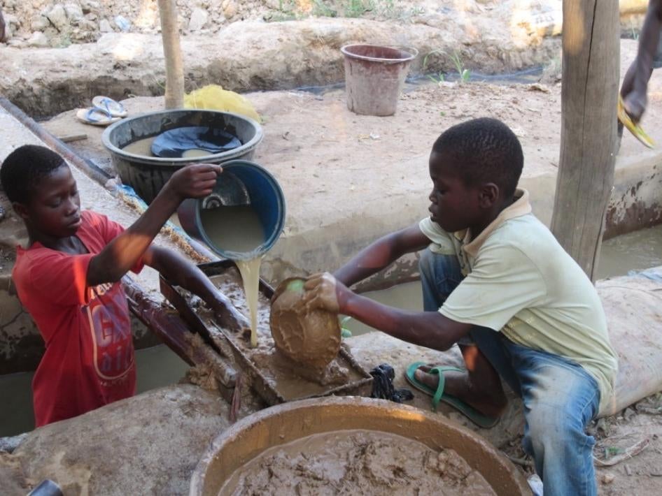 Two boys at work in a mining site