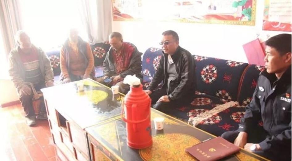 Five men sitting on a couch