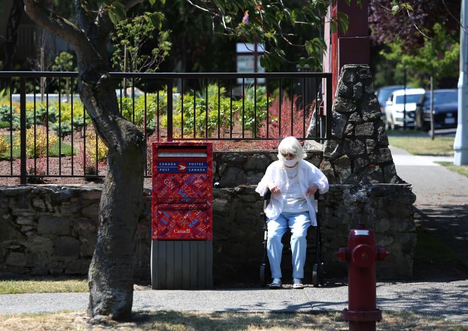 A woman sits to take a rest as heat wave hits Western Canada on June 30, 2021 in Victoria, British Columbia, Canada. © 2021 Mert Alper Dervis/Anadolu Agency via Getty Images